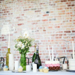 cake beside candles and flowers