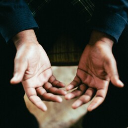 person showing both palms while sitting on chair