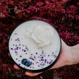 person holding white cream on white and blue floral ceramic plate